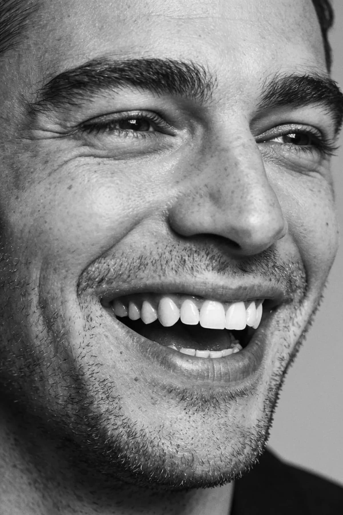 Ottoline: a man laughing, a tight black and white portrait